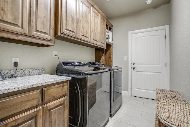3201 Steamers Ct, Granbury, TX 76049 - laundry area with cabinet space, separate washer and dryer, and light tile patterned flooring