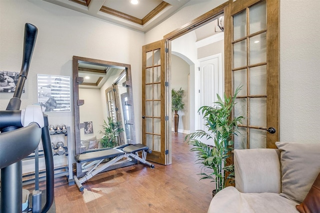 3201 Steamers Ct, Granbury, TX 76049 - exercise area featuring crown molding, wood finished floors, arched walkways, and coffered ceiling
