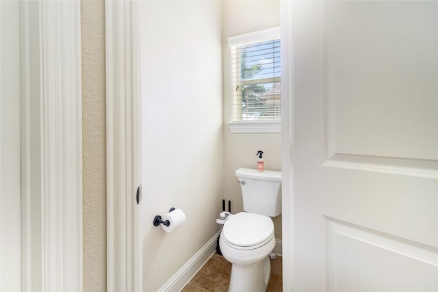 2901 NE Regents Park Ln, Garland, TX 75043 - bathroom with toilet, baseboards, and tile patterned flooring