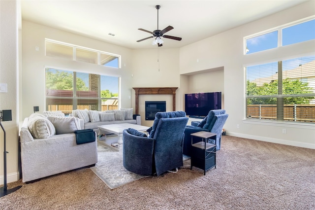 2901 NE Regents Park Ln, Garland, TX 75043 - living area featuring carpet, ceiling fan, plenty of natural light, and a glass covered fireplace