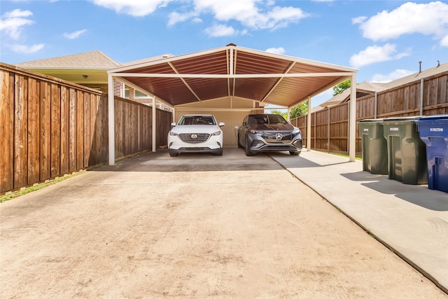 2901 NE Regents Park Ln, Garland, TX 75043 - view of parking featuring concrete driveway and a carport