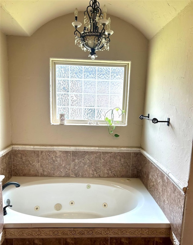 2663 Rodeo Dr, Quinlan, TX 75474 - bathroom featuring a whirlpool tub and a chandelier