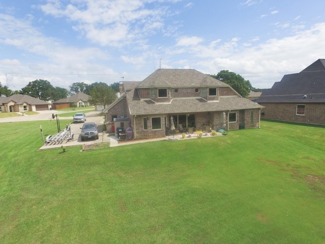2663 Rodeo Dr, Quinlan, TX 75474 - rear view of house featuring a yard, a chimney, and a patio area