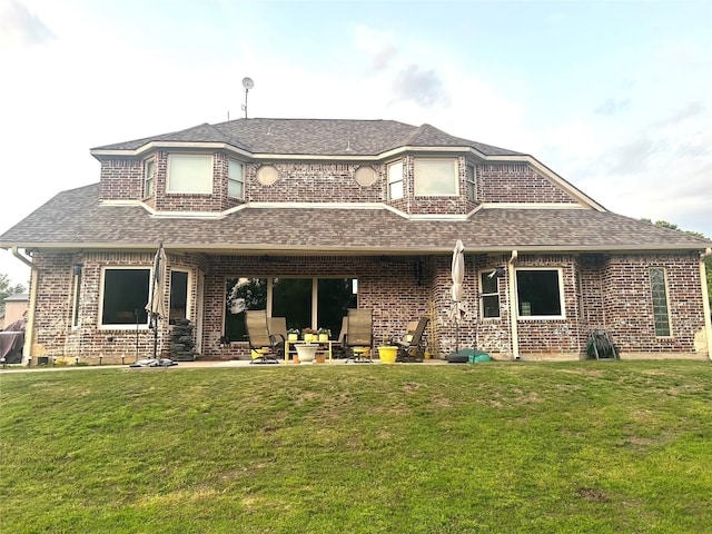 2663 Rodeo Dr, Quinlan, TX 75474 - back of property featuring roof with shingles, a lawn, and a patio area