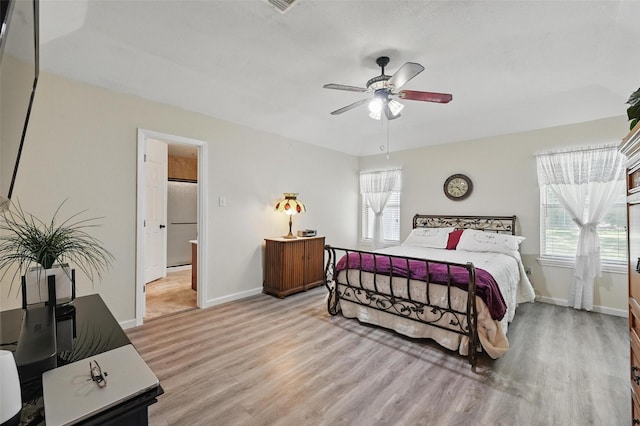 685 Cardinal Ridge Rd, Burleson, TX 76028 - bedroom with wood finished floors, baseboards, ceiling fan, and freestanding refrigerator