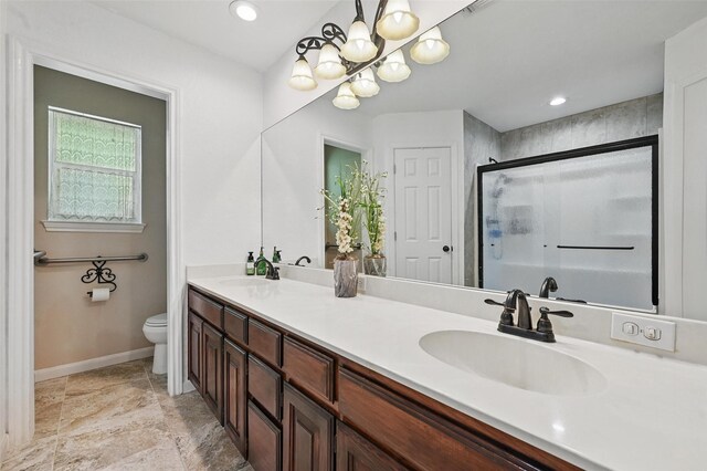 685 Cardinal Ridge Rd, Burleson, TX 76028 - full bathroom featuring toilet, double vanity, a stall shower, baseboards, and a chandelier