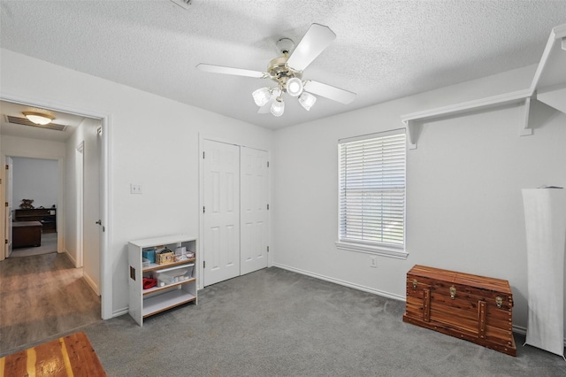 685 Cardinal Ridge Rd, Burleson, TX 76028 - unfurnished bedroom with a textured ceiling, baseboards, a closet, and ceiling fan