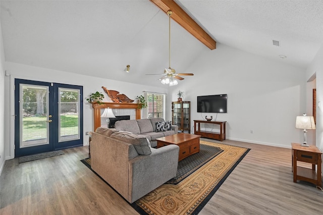 685 Cardinal Ridge Rd, Burleson, TX 76028 - living area with beam ceiling, wood finished floors, french doors, a fireplace, and a ceiling fan
