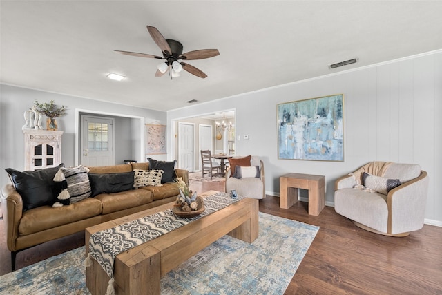 815 N Spikes Rd, Corsicana, TX 75110 - living room with ceiling fan, wood finished floors, baseboards, a chandelier, and crown molding