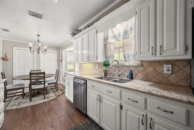 815 N Spikes Rd, Corsicana, TX 75110 - kitchen with stainless steel dishwasher, a sink, dark wood finished floors, a chandelier, and white cabinets