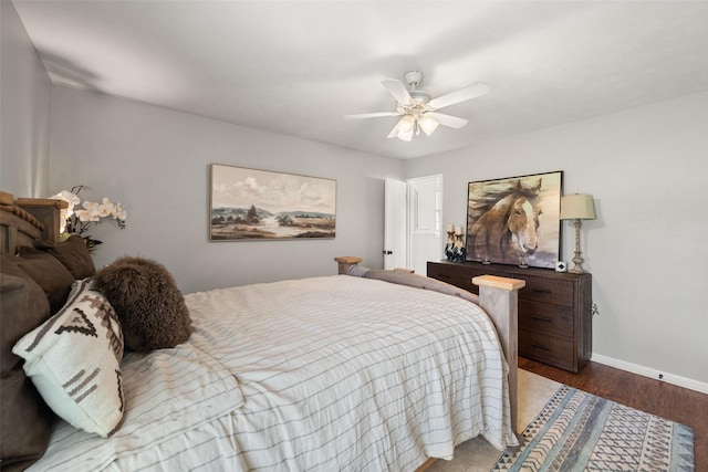 815 N Spikes Rd, Corsicana, TX 75110 - bedroom with baseboards, wood finished floors, and a ceiling fan