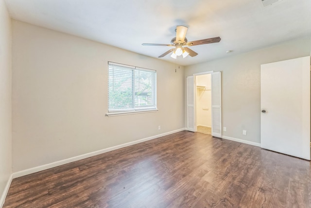 311 Franklin Dr, Euless, TX 76040 - unfurnished bedroom featuring wood finished floors, baseboards, ceiling fan, and a spacious closet