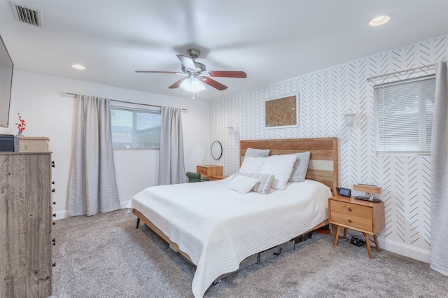 502 E Alexander Ln, Euless, TX 76040 - bedroom with wallpapered walls, an accent wall, baseboards, carpet flooring, and a ceiling fan