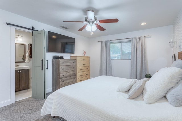 502 E Alexander Ln, Euless, TX 76040 - carpeted bedroom featuring a sink, a barn door, baseboards, and ceiling fan