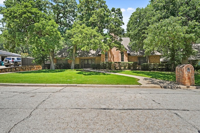29 Timbergreen Cir, Denton, TX 76205 - obstructed view of property featuring brick siding and a front lawn