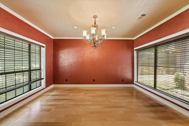 29 Timbergreen Cir, Denton, TX 76205 - empty room featuring a chandelier, light wood-style floors, ornamental molding, baseboards, and a textured ceiling