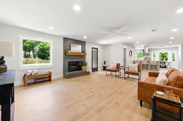 6713 Genoa Rd, Fort Worth, TX 76116 - living room featuring a fireplace, a ceiling fan, recessed lighting, baseboards, and light wood finished floors