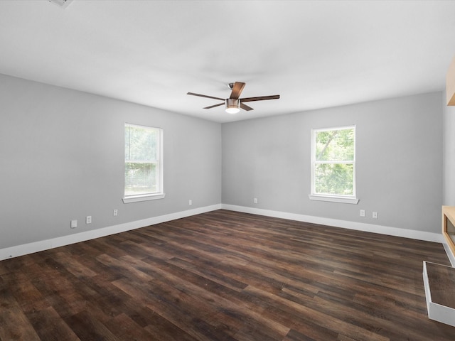 828 Ronald St, White Settlement, TX 76108 - empty room featuring a ceiling fan, dark wood-style floors, and baseboards