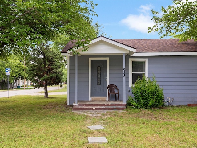 828 Ronald St, White Settlement, TX 76108 - view of front of property with a front yard, roof with shingles, and covered porch