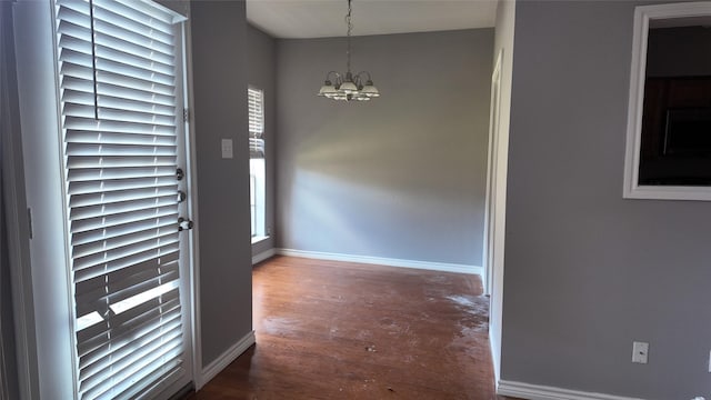2405 Northlake Ct, Irving, TX 75038 - unfurnished room with a chandelier, baseboards, and wood finished floors