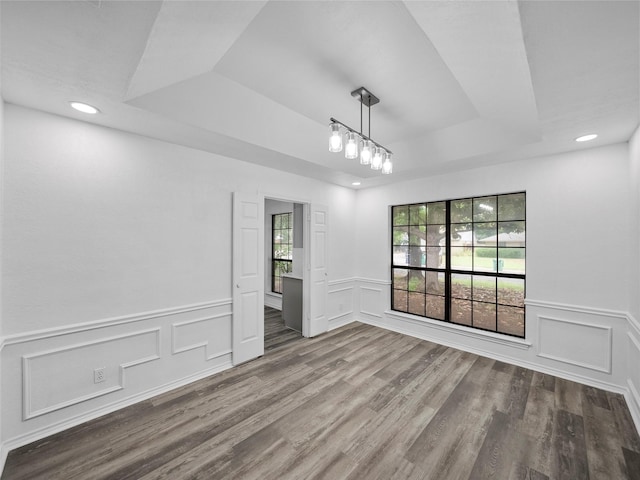 2219 N Lake Trl, Denton, TX 76201 - empty room featuring a tray ceiling, a decorative wall, wood finished floors, wainscoting, and recessed lighting