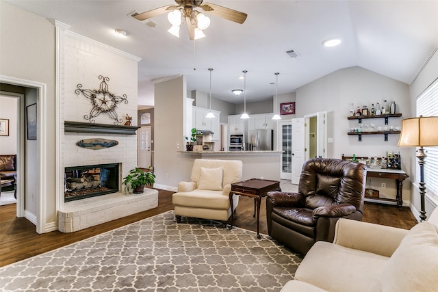 601 Natchez Ct, Hurst, TX 76054 - living room featuring a ceiling fan, dark wood finished floors, vaulted ceiling, a brick fireplace, and baseboards