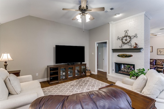 601 Natchez Ct, Hurst, TX 76054 - living area featuring ceiling fan, vaulted ceiling, wood finished floors, a fireplace, and baseboards