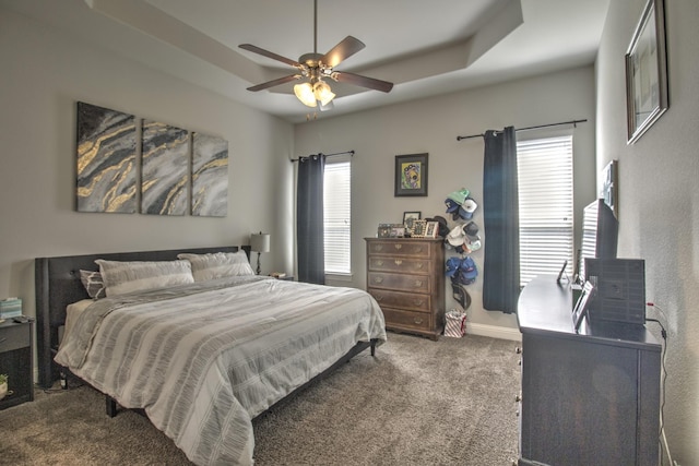 3713 Blessington Dr, Frisco, TX 75036 - carpeted bedroom with multiple windows, baseboards, a ceiling fan, and a raised ceiling