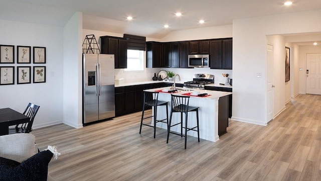1912 Coleto Rd, Crandall, TX 75114 - kitchen featuring appliances with stainless steel finishes, light countertops, light wood finished floors, a kitchen breakfast bar, and an island with sink