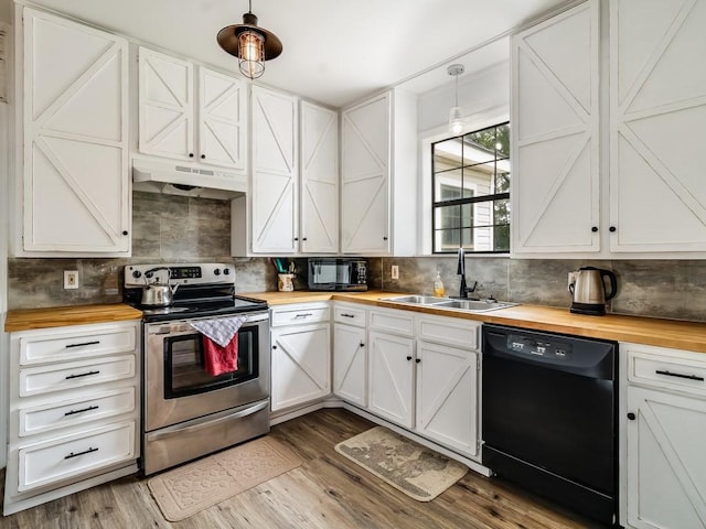 1501 N Business 45, Corsicana, TX 75110 - kitchen with butcher block counters, black appliances, and under cabinet range hood