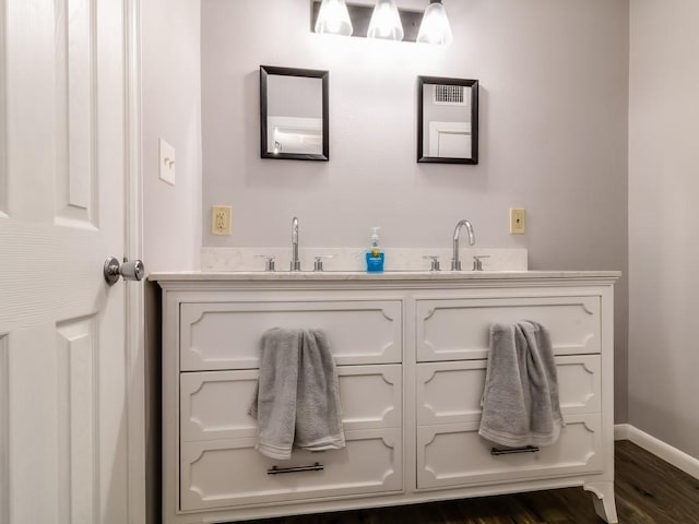 1501 N Business 45, Corsicana, TX 75110 - bathroom with double vanity, baseboards, and wood finished floors