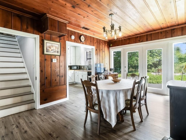 1501 N Business 45, Corsicana, TX 75110 - dining space featuring wood walls, wood ceiling, stairs, dark wood finished floors, and a chandelier