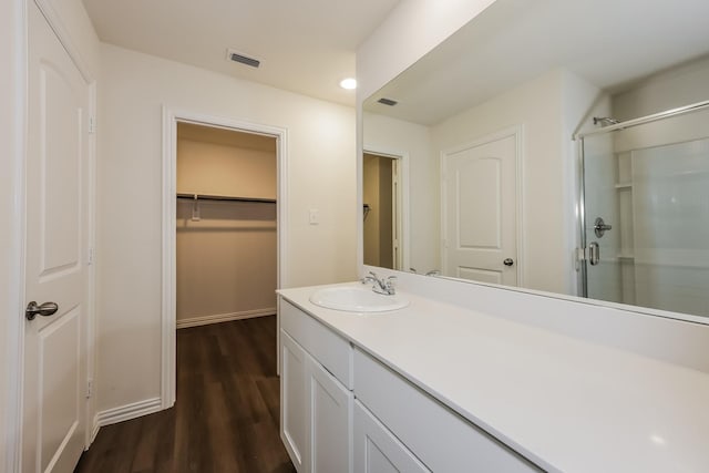 336 Bounding Main St, Gun Barrel City, TX 75156 - full bathroom featuring vanity, a stall shower, a spacious closet, wood finished floors, and baseboards