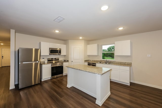 336 Bounding Main St, Gun Barrel City, TX 75156 - kitchen with stainless steel appliances, a sink, dark wood-type flooring, white cabinetry, and recessed lighting