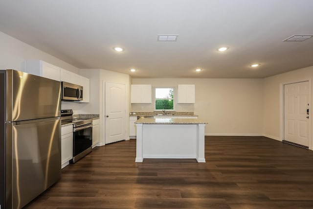 336 Bounding Main St, Gun Barrel City, TX 75156 - kitchen with appliances with stainless steel finishes, dark wood-style floors, a center island, recessed lighting, and white cabinetry