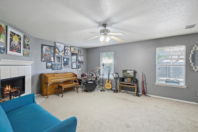 521 Ryan St, Saginaw, TX 76179 - misc room featuring a fireplace, a textured ceiling, ceiling fan, and carpet floors