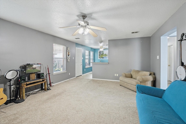 521 Ryan St, Saginaw, TX 76179 - carpeted living area with a textured ceiling, ceiling fan, and baseboards