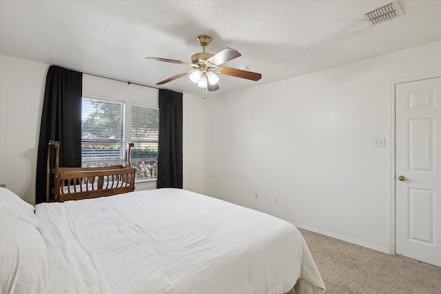 521 Ryan St, Saginaw, TX 76179 - bedroom featuring light colored carpet, a textured ceiling, a ceiling fan, and baseboards