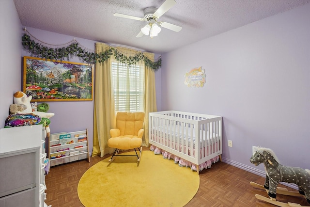 521 Ryan St, Saginaw, TX 76179 - bedroom featuring a textured ceiling, a nursery area, and a ceiling fan