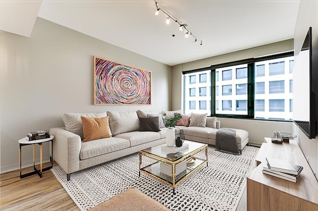 1200 Main St Unit 2508, Dallas, TX 75202 - living room with track lighting, light wood-style floors, and baseboards