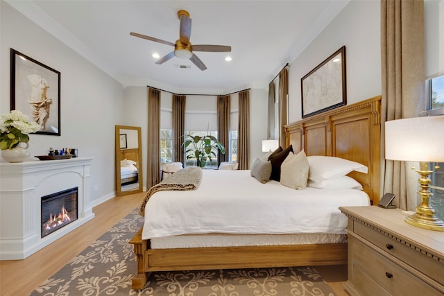 6501 Glenhope Cir S, Colleyville, TX 76034 - bedroom with multiple windows, light wood-style floors, ornamental molding, a glass covered fireplace, and recessed lighting