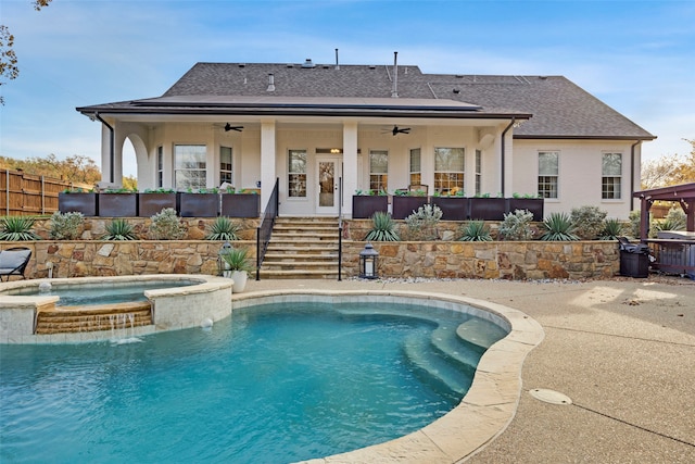 6501 Glenhope Cir S, Colleyville, TX 76034 - back of house featuring a ceiling fan, a shingled roof, and a pool with connected hot tub