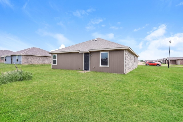 819 S Sutton St, Mabank, TX 75147 - back of property with a lawn and roof with shingles