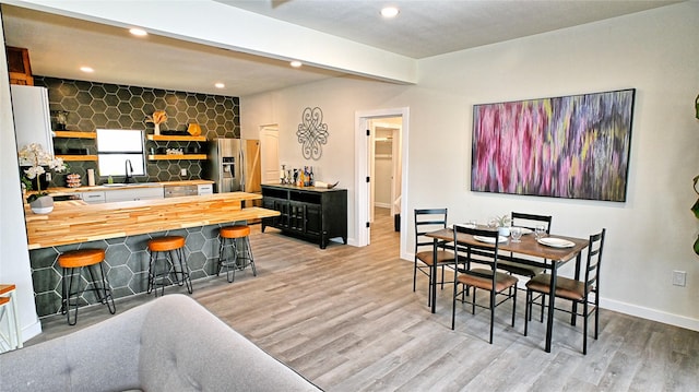 209 N Broad St, Saint Jo, TX 76265 - dining space with light wood-type flooring, baseboards, and recessed lighting