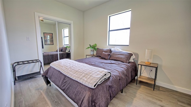 209 N Broad St, Saint Jo, TX 76265 - bedroom featuring multiple windows, wood finished floors, baseboards, and a closet