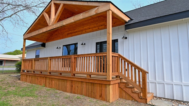 209 N Broad St, Saint Jo, TX 76265 - rear view of property with a shingled roof, board and batten siding, and a deck