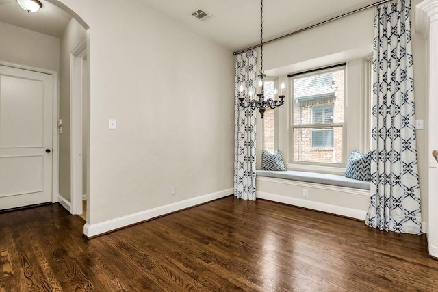 5909 Woodwind Dr, Plano, TX 75093 - unfurnished dining area featuring arched walkways, a chandelier, dark wood-style floors, and baseboards