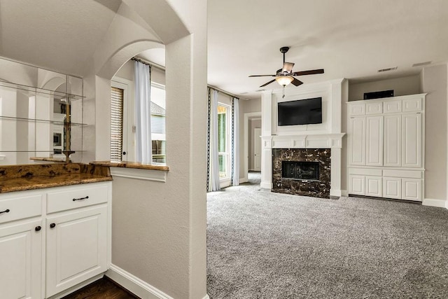 5909 Woodwind Dr, Plano, TX 75093 - kitchen with ceiling fan, arched walkways, a fireplace, baseboards, and open floor plan