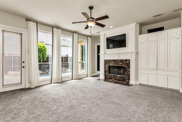 5909 Woodwind Dr, Plano, TX 75093 - unfurnished living room featuring ceiling fan, carpet, a high end fireplace, and recessed lighting