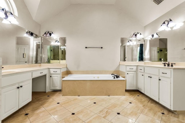 5909 Woodwind Dr, Plano, TX 75093 - full bath featuring high vaulted ceiling, a garden tub, two vanities, and tile patterned floors